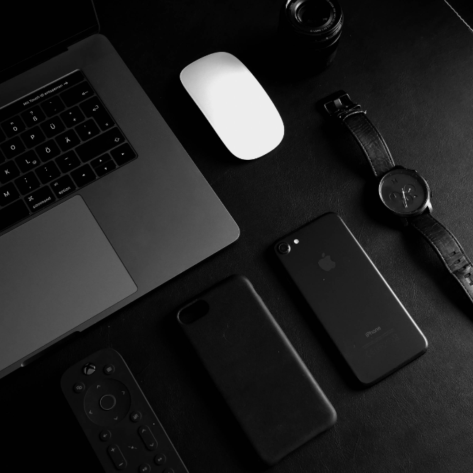 dark themed watch with laptop and mobile